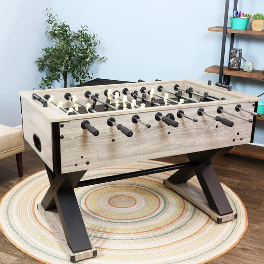 Furniture-style foosball table with extended rods in a home game room