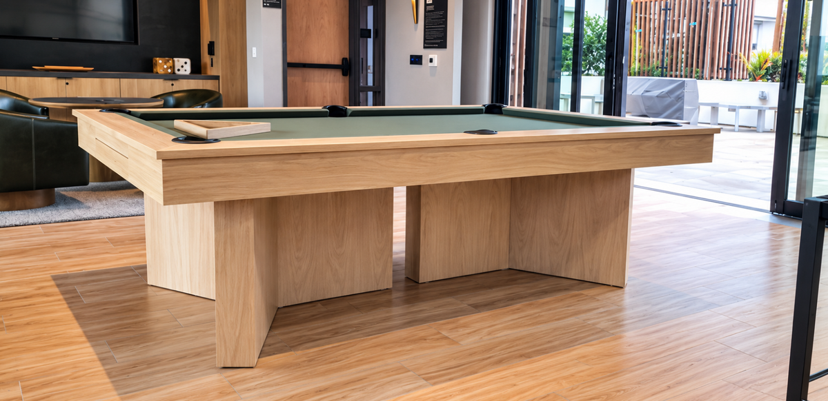 Contemporary Infinity Pool Table by Modern Billiards featuring a light wood finish and modern architectural base in a luxury home.