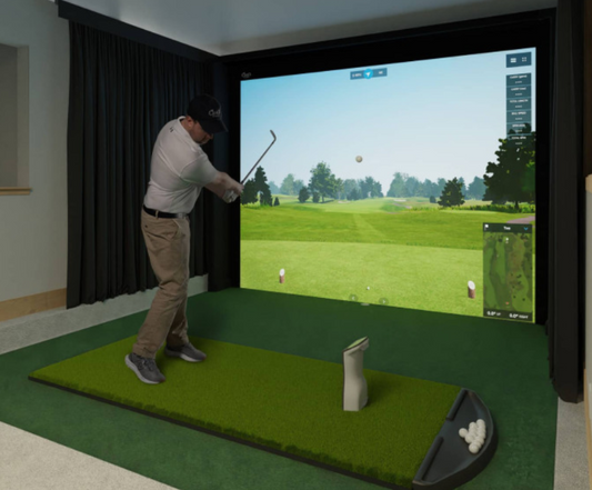 Golfer using a Carl’s Place DIY golf simulator enclosure in a home golf room
