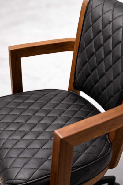 Close-up of Walnut Prohibition game chair with diamond-quilted black upholstery