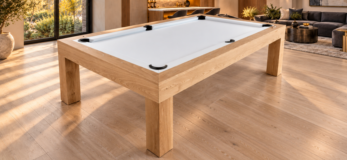 Elevated corner view of the natural white oak Rift pool table with white felt in a furnished modern game room.
