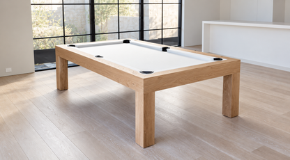 Modern Natural White Oak Rift Pool Table with white felt, square legs, and black pockets beside large windows.